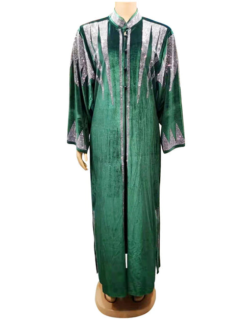 A flowing golden velvet abaya with intricate African-inspired embroidery in gold or metallic thread