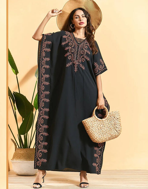 Embrace Bohemian Breezes: Embroidered Batwing Abaya with Flowing Pleated Skirt